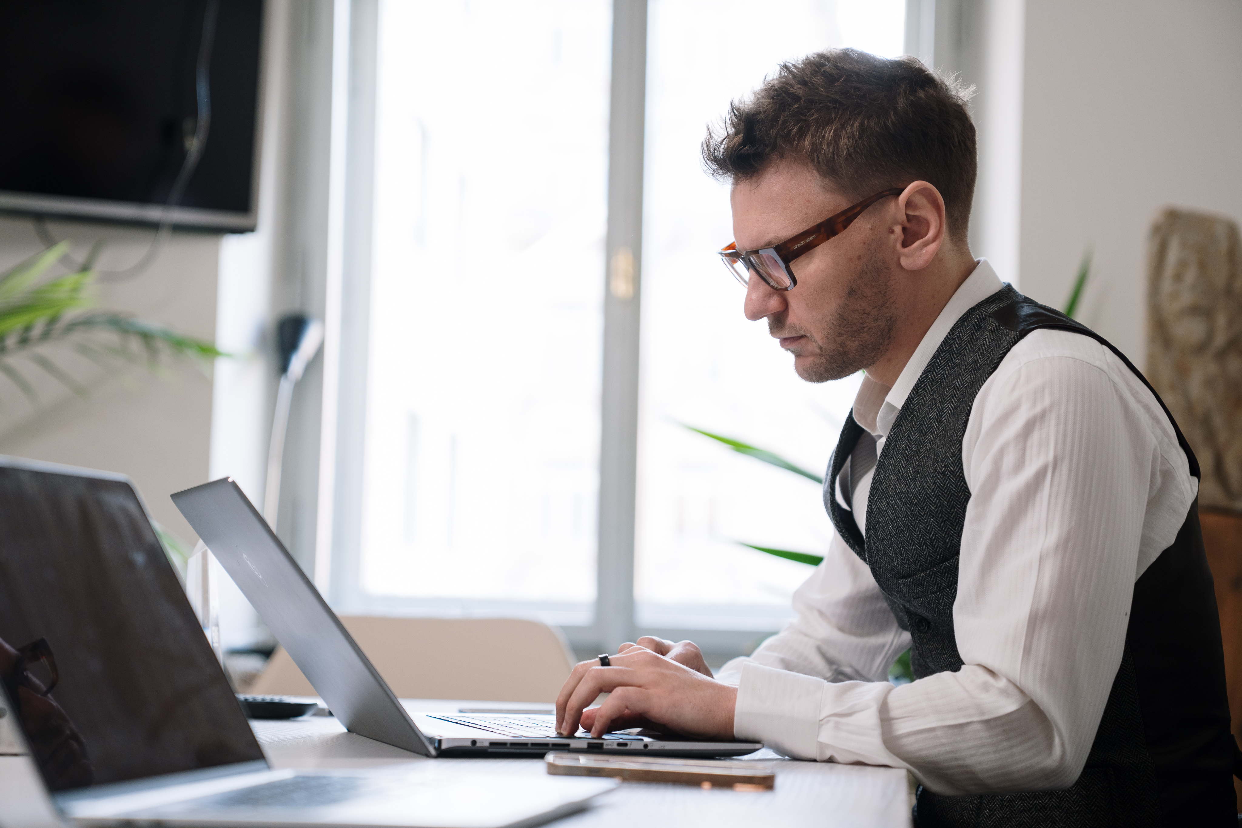 Person sitting on couch working on laptop